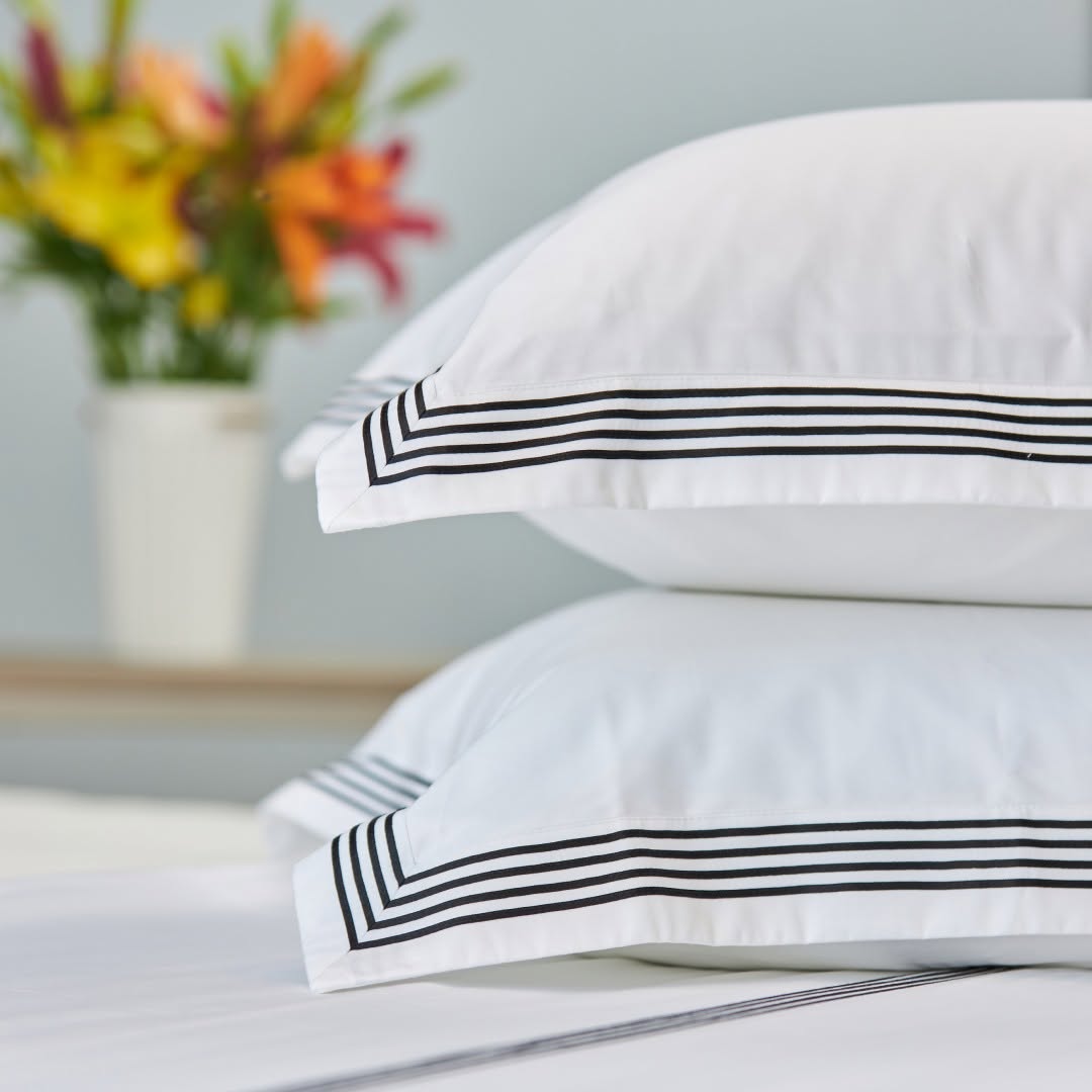 White Melchiah pillows finished with black tailored borders